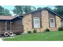 This home features a stone facade and covered front porch, with well-maintained landscaping at 865 Countryside Ln, Columbus, IN 47201