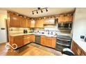 Well-lit kitchen featuring wooden cabinets, stainless steel appliances, and functional design at 865 Countryside Ln, Columbus, IN 47201