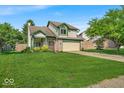 Charming two-story home with a well-manicured lawn, lovely landscaping and inviting curb appeal at 8908 Sunningdale Blvd, Indianapolis, IN 46234