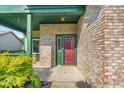 Covered front porch showing the home's brick facade and red front door at 8908 Sunningdale Blvd, Indianapolis, IN 46234