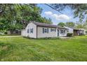 A well-maintained home with blue shutters and a spacious yard is perfect for outdoor activities at 903 Sunset Dr, Lebanon, IN 46052
