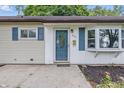 A charming home features a blue front door, blue shutters, and a bay window for added curb appeal at 903 Sunset Dr, Lebanon, IN 46052