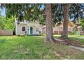 Charming exterior of home with well-maintained lawn and mature trees at 923 42Nd St, Indianapolis, IN 46205