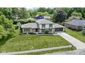 An aerial view showcases this beautiful home, its manicured lawn, mature trees, and surrounding neighborhood at 10502 E Lakeshore Dr, Carmel, IN 46033