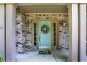 Charming front door with sidelights and brick surround, adorned with a decorative wreath for a welcoming entrance at 10965 Fairway Ridge Ln, Fishers, IN 46037