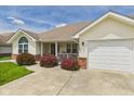 Well-maintained ranch with attached garage, landscaping, covered porch area and brick accents at 1108 Northfield Ln, Anderson, IN 46011