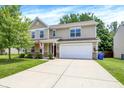 Inviting two-story home with a spacious driveway, manicured lawn, and traditional curb appeal at 11437 High Grass Dr, Indianapolis, IN 46235