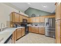 Well-lit kitchen with stainless steel appliances, ample counter space, and tile backsplash at 1146 Distinctive Way, Greenfield, IN 46140