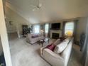 Expansive living room with high ceilings, fireplace, plush carpeting, and an adjacent dining area at 11621 Coastal Dr, Indianapolis, IN 46229
