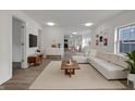 Bright, open-concept living room with modern decor, wood floors, and abundant natural light at 1411 N Grant Ave, Indianapolis, IN 46201