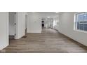 Spacious room featuring wood floors and generous natural light, enhanced by a minimalist aesthetic at 1411 N Grant Ave, Indianapolis, IN 46201