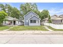 Quaint two-story home with a well-manicured front lawn at 1425 N Grant Ave, Indianapolis, IN 46201