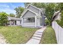 Charming two-story home with a well-manicured front lawn at 1425 N Grant Ave, Indianapolis, IN 46201