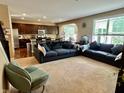 Open-concept living room with a large sofa, plush carpeting, and an archway to other living spaces at 1518 Valdarno Dr, Greenwood, IN 46143