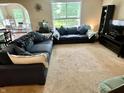 Comfortable living room featuring a large sectional sofa, entertainment center, and plenty of natural light at 1518 Valdarno Dr, Greenwood, IN 46143