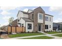 This exterior home view showcases manicured landscaping with a wood privacy fence, a stone walkway, and mixed material facade at 1675 Solebar Way, Westfield, IN 46074