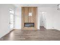 Bright and airy living room with a modern fireplace, hardwood floors and modern white walls at 1675 Solebar Way, Westfield, IN 46074