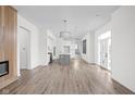 Spacious living area with open floor plan, hardwood floors, fireplace, and modern lighting at 1675 Solebar Way, Westfield, IN 46074