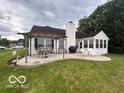Backyard area showcasing a patio, pergola, and a sunroom with lots of natural light at 2018 Alysheba Dr, Indianapolis, IN 46234