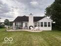 View of the backyard patio with a pergola, a sunroom, and a seating area at 2018 Alysheba Dr, Indianapolis, IN 46234