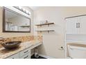 Well-lit bathroom featuring a custom sink, wood shelves, ample cabinet space, and a toilet at 2210 Bridlewood Dr, Franklin, IN 46131