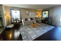 Sunlit living room featuring hardwood floors, a comfortable sofa set, a stylish area rug, and bright windows at 2210 Bridlewood Dr, Franklin, IN 46131