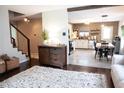 Open concept living room with wood floors and a view into the kitchen and dining area at 2210 Bridlewood Dr, Franklin, IN 46131