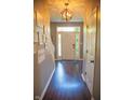 Inviting entryway with hardwood floors, a decorative light fixture, and a bright, welcoming ambiance at 2233 Burgundy Way, Plainfield, IN 46168