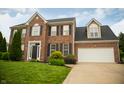 Beautiful two-story brick home with a manicured lawn and attached two-car garage at 2233 Burgundy Way, Plainfield, IN 46168