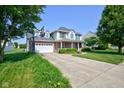 Inviting two-story home with a spacious driveway and well-manicured front lawn and a basketball hoop at 2234 Burgundy Way, Plainfield, IN 46168