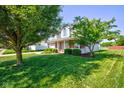 Lovely two-story home surrounded by lush green lawn, mature trees and tasteful landscaping at 2234 Burgundy Way, Plainfield, IN 46168