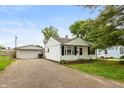 Cozy home with gravel driveway and detached garage, perfect for storage and projects at 2704 13Th St, Columbus, IN 47201