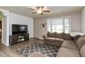Inviting living room with comfortable sectional sofa, modern ceiling fan, and stylish rug at 2704 13Th St, Columbus, IN 47201