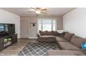 Welcoming living room with a cozy sectional couch, ceiling fan, and a view of the outdoors at 2704 13Th St, Columbus, IN 47201