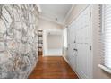 Foyer featuring hardwood floors, a stone wall and views into the living areas at 2947 Talping Row, Indianapolis, IN 46268