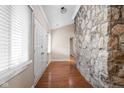 Entryway with wood floors, stone accent wall, closet doors and bright natural light at 2947 Talping Row, Indianapolis, IN 46268
