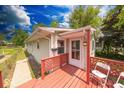 Inviting home entrance with a red deck and a well-maintained front yard at 3220 Newton Ave, Indianapolis, IN 46201