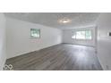 Bright living room with large windows and neutral gray flooring, perfect for modern living at 3220 Newton Ave, Indianapolis, IN 46201