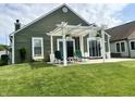 Backyard patio with a white pergola and patio furniture creating an outdoor space at 3404 Maritime Dr, Indianapolis, IN 46214