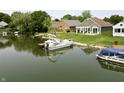 Waterfront view of the back of the home with a boat docked in the water at 3404 Maritime Dr, Indianapolis, IN 46214