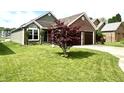 Well-manicured front yard with a tree adding to the home's curb appeal at 3404 Maritime Dr, Indianapolis, IN 46214