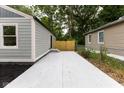 Backyard patio featuring a modern gray siding and a new wooden fence at 3614 N Whittier Pl, Indianapolis, IN 46218