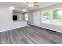 Open-concept living room with lots of natural light and modern floors at 3614 N Whittier Pl, Indianapolis, IN 46218