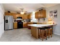 Spacious kitchen features wooden cabinets, modern appliances, and a cozy breakfast bar at 3645 Richland Dr, Columbus, IN 47203