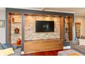 Entertainment center with stone backsplash and custom storage solutions, designed for media and display at 3713 Coventry Way, Carmel, IN 46033