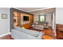 Inviting living room with a stone accent wall, custom built-ins, and comfortable seating, perfect for relaxation at 3713 Coventry Way, Carmel, IN 46033