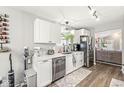 Functional kitchen featuring stainless steel appliances, white cabinetry, and a view to the living space at 4167 Apple Creek Dr, Indianapolis, IN 46235