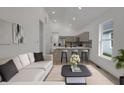 Bright living room with a modern kitchen, comfortable sofa, and contemporary decor at 4230 Kingsley Dr, Indianapolis, IN 46205