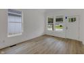 Inviting room featuring new windows, fresh white paint, and modern flooring at 4230 Kingsley Dr, Indianapolis, IN 46205