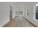 Bright living room with views of the outside through several windows and a door at 4234 Kingsley Dr, Indianapolis, IN 46205